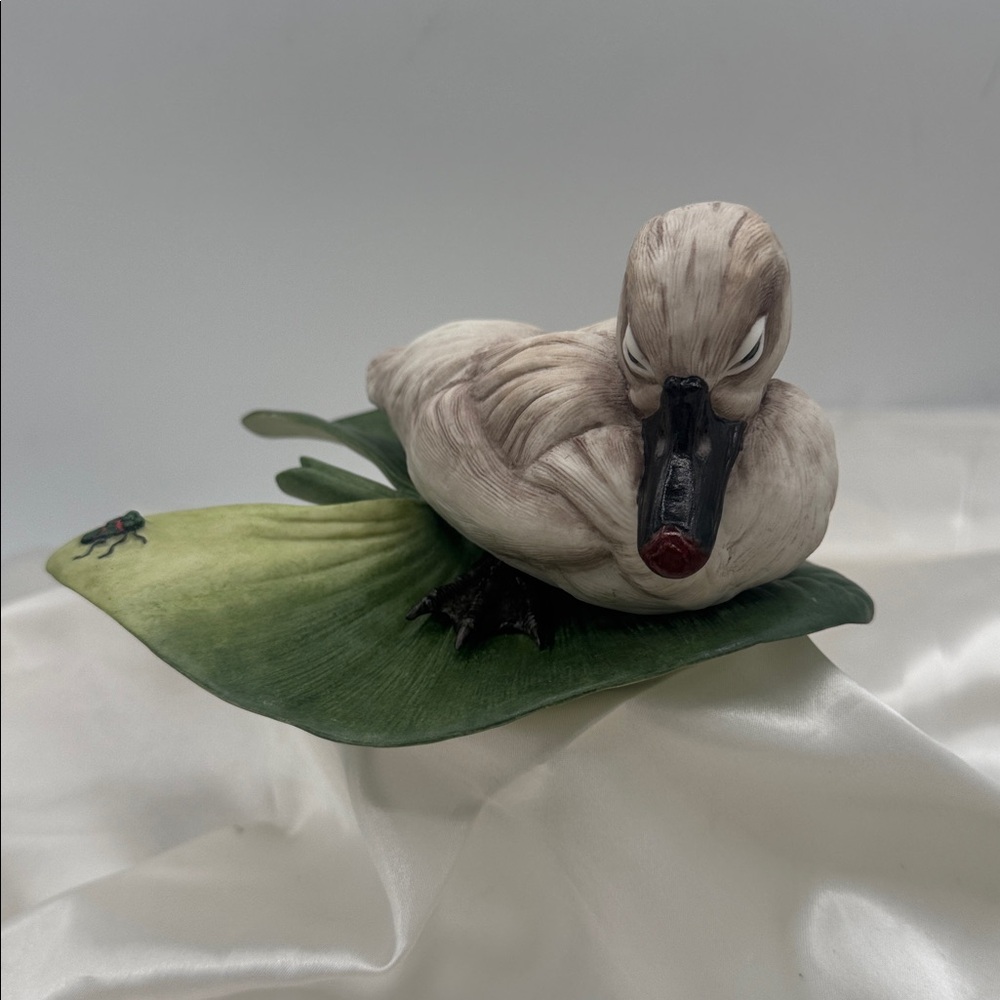 A porcelain figurine of a cygnet on a lily pad, by Boehm Porcelain, # 400-13